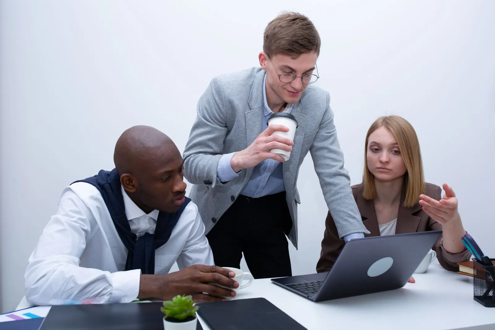 Colleagues reviewing work together on a laptop
